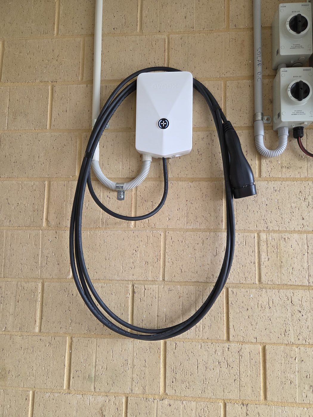 Evnex EV charger installed on a garage wall